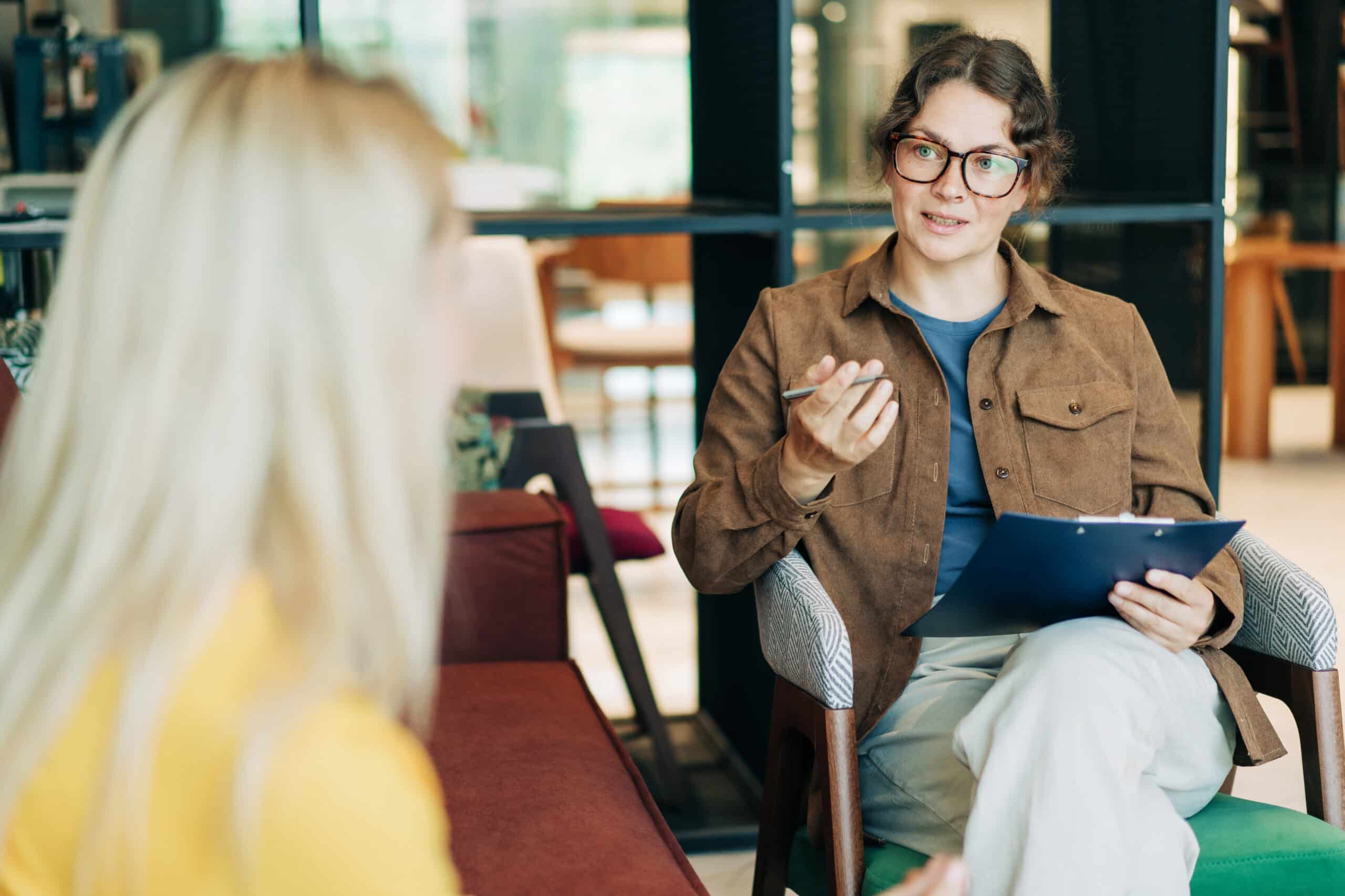 A female psychologist advises a client. Portrait of a professional modern woman. HR hires and conducts interviews. A female psychologist advises a client. Portrait of a professional modern woman. HR hires and conducts interviews.